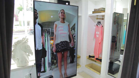 7일 에프엑스기어는 자사 3D 솔루션 '에프엑스미러'를 미국 패션업체 와일드폭스에 공급했다고 밝혔다. 와일드폭스 한 매장에서 고객이 CG로 구현된 의상을 체험하고 있다.  사진= 에프엑스기어 제공